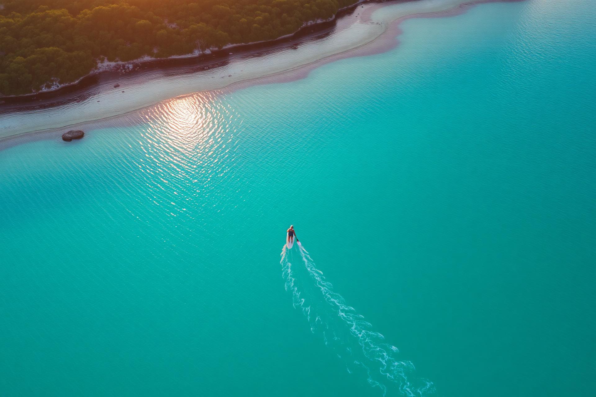 Aerial view of paddleboarder on turquoise water